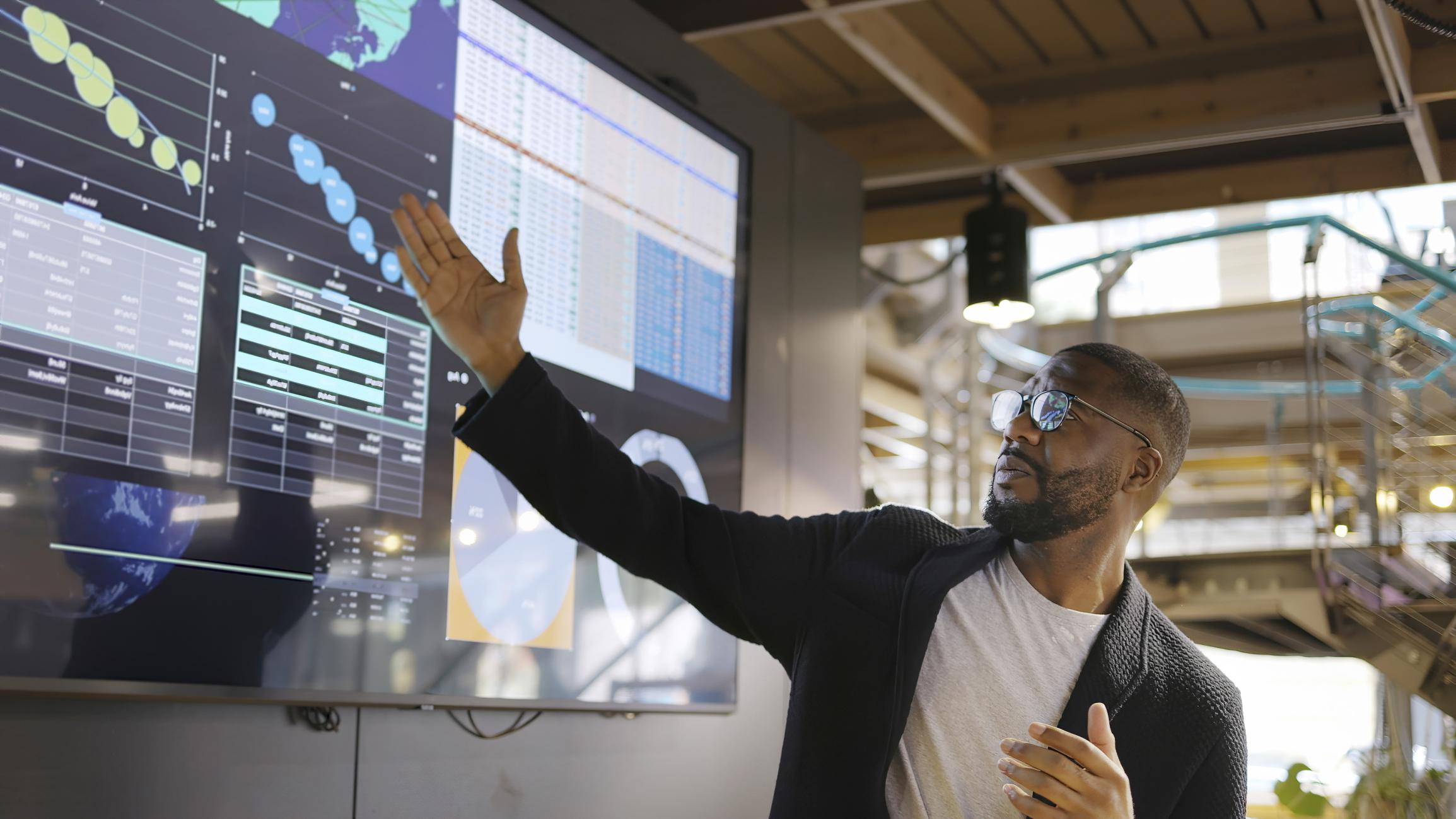 man presenting data on screen